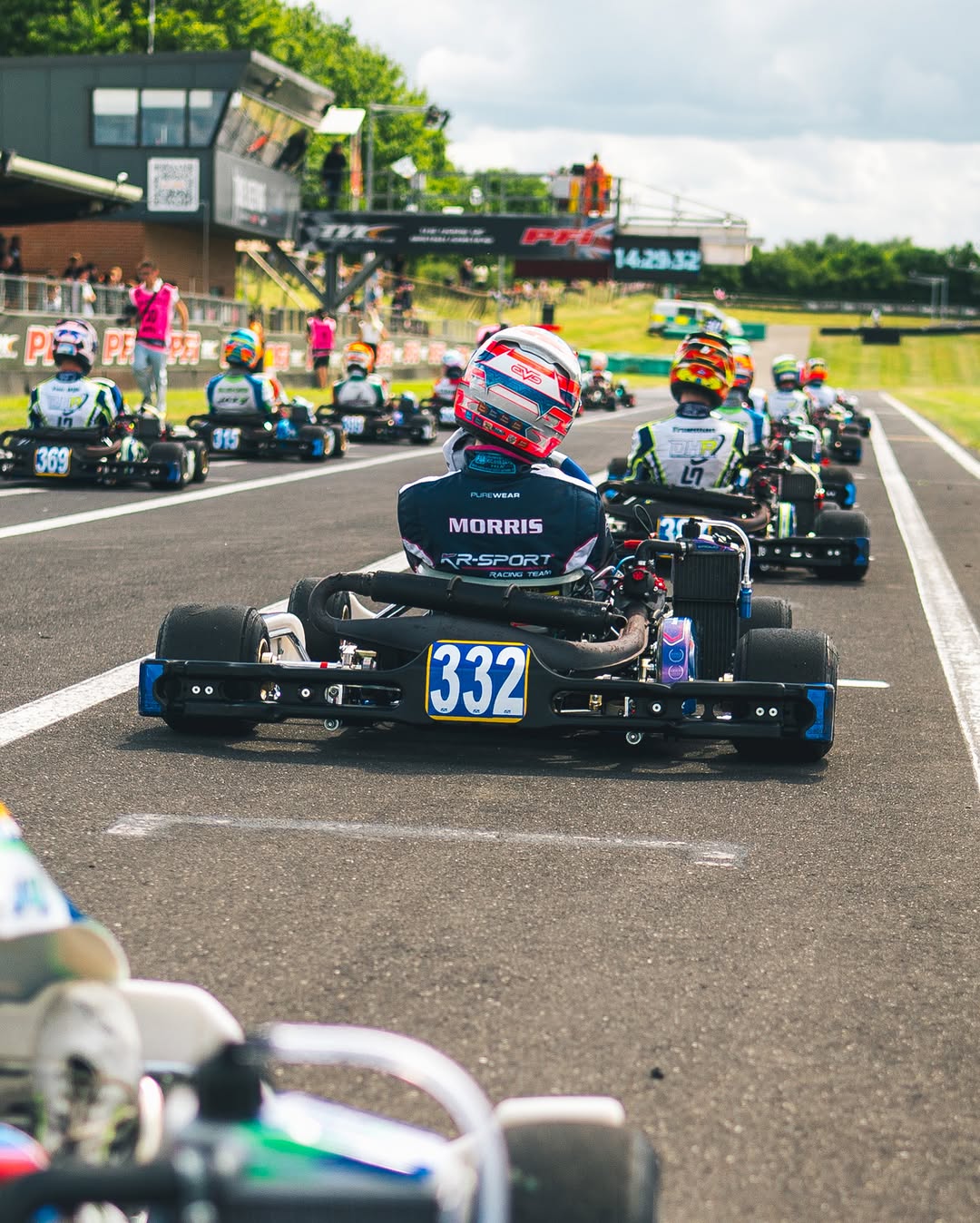 Eva seen from behind in her kart on the grid at PF International, MORRIS and KR-Sport across her back, kart number 332